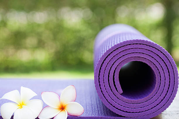 istock purple yoga mat and a flowers 615903724
