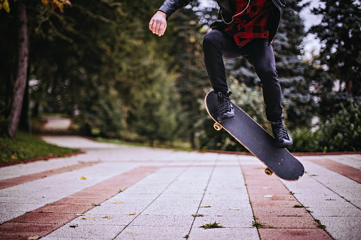 Hipster jumping with a skateboard.