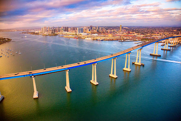 san diego skyline beyond the coronado bridge - san diego california skyline california san diego bay imagens e fotografias de stock