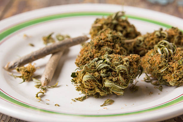 istock Marijuana buds and joints in the white plate 615907730