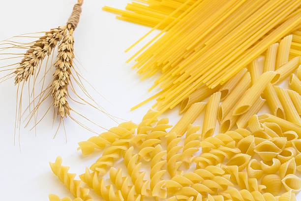 istock Spikelets of wheat and several types of pasta 615908506