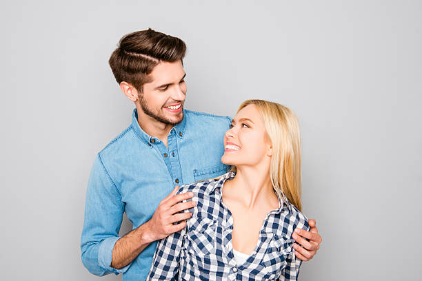 istock Handsome young guy looking at his his smiling girlfriend 615910194