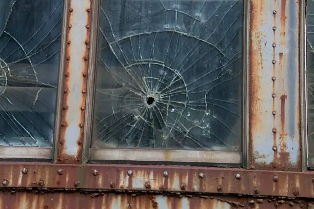 This is the window on an old traincar that had been busted by a small object
