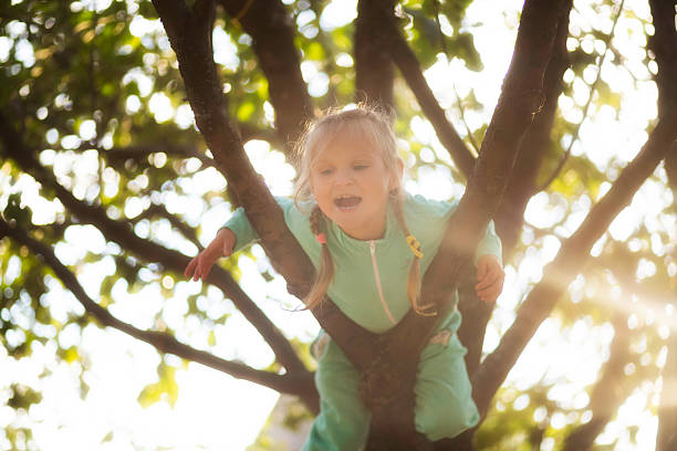 istock Little girl with pigtails on the tree 615913782