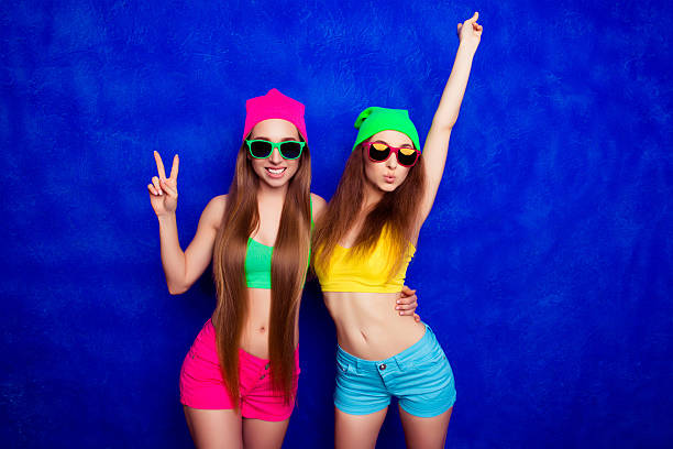 istock Stylish young woman in glasses pouting while her sister 615913896