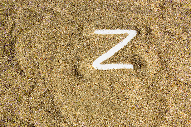 istock writing with  letter J made of  sand isolated  white inside 615915830