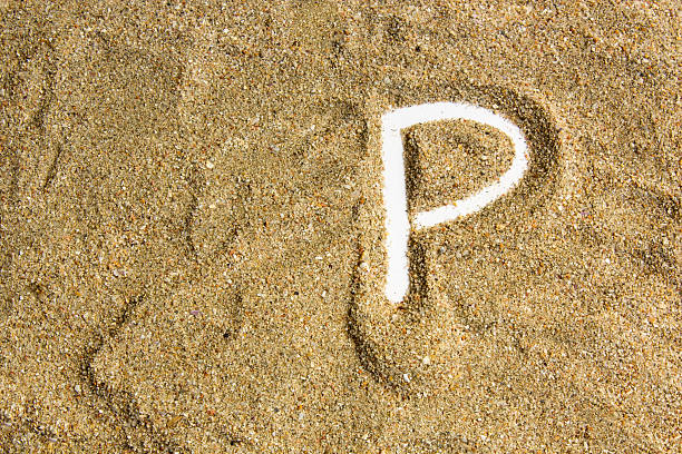 istock writing with  letter J made of  sand isolated  white inside 615915914
