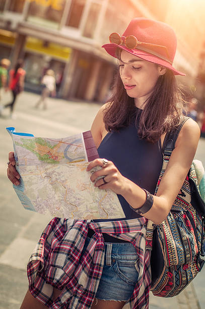 istock Young tourist in the city looking a map 615916410