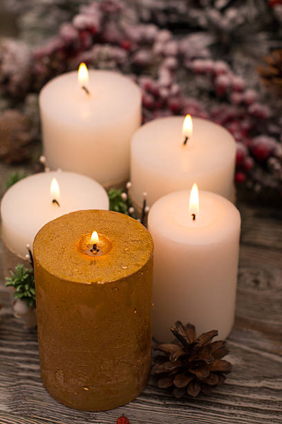 istock Fir branch in snow, lighted candle, cone on wooden background 615916480