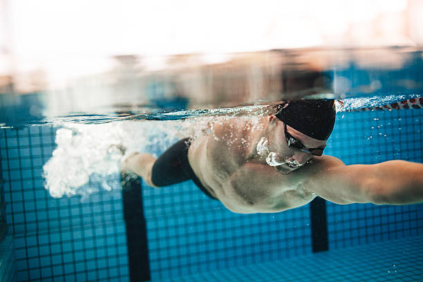 istock Pro male swimmer in action inside swimming pool 615916788