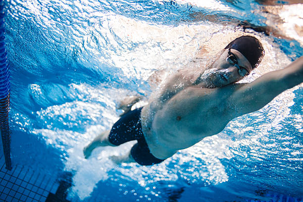 istock Professional swimmer practising for race in pool 615916984