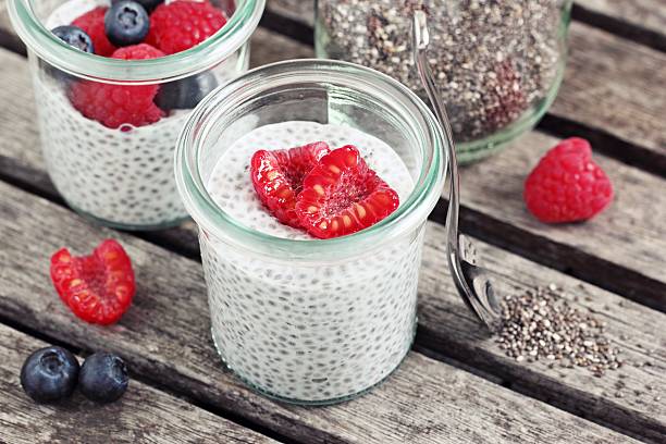 istock Overnight chia seeds pudding with fresh raspberries in glass jar 615917040