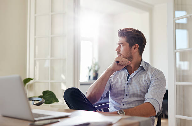 istock Thoughtful businessman sitting home office 615917540