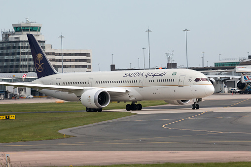 Manchester, United Kingdom - May 8, 2016: Saudia Boeing 787-9 wide-body passenger plane (HZ-ARA) taxiing on Manchester International Airport tarmac.