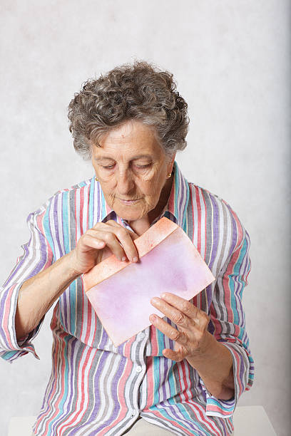 istock Old woman and a letter 615917704