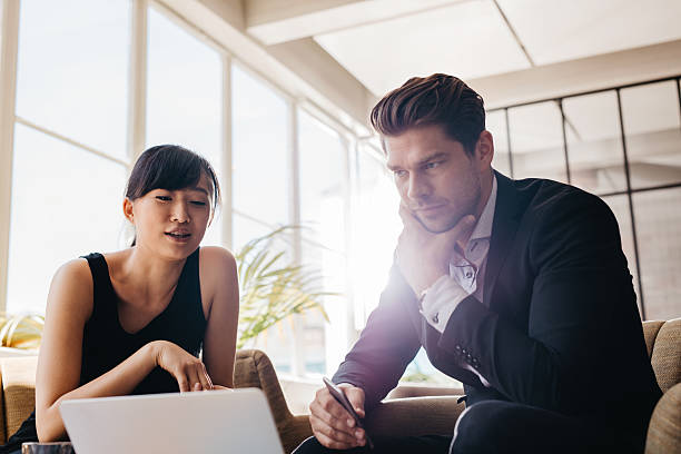 istock Young businesspeople working on laptop in office 615918182