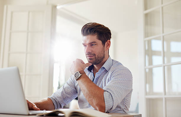 istock Young man at home working on laptop 615918384
