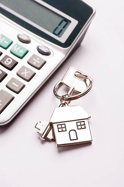istock Key and house-shaped keyring and calculator - mortgage concept 615919018