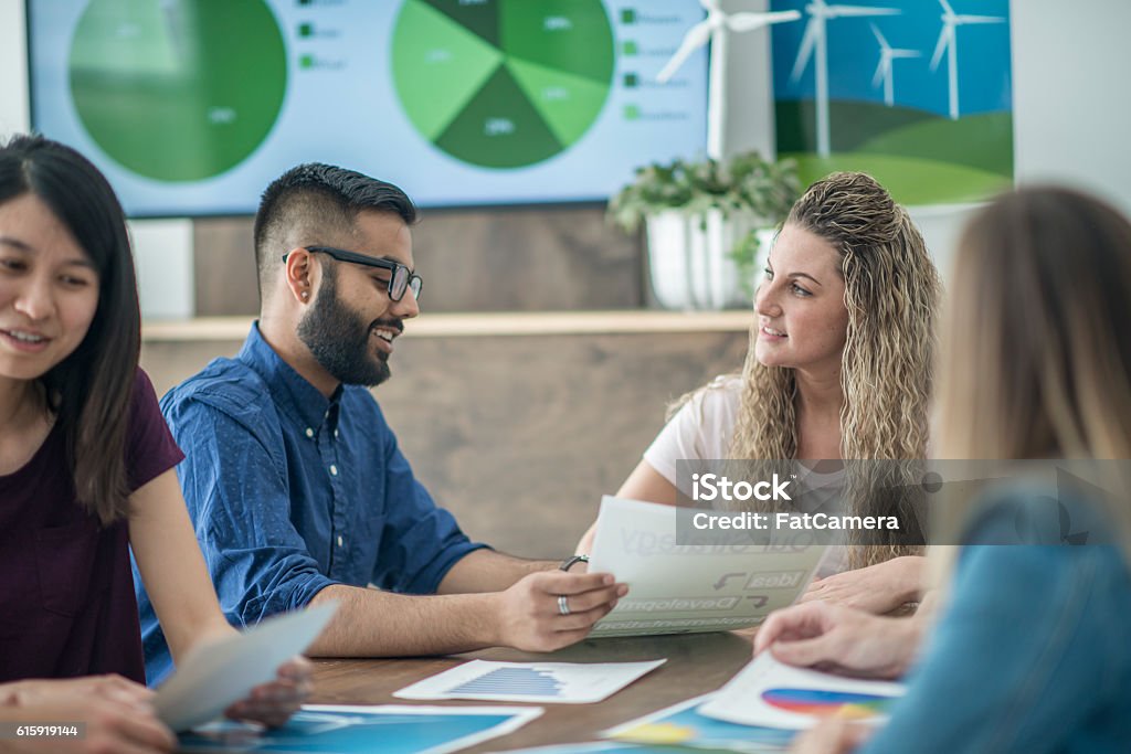 Alternative Green Energy Sources A multi-ethnic group of entrepreneurs and business professionals are discussing clean energy concepts in the boardroom. Environment Stock Photo