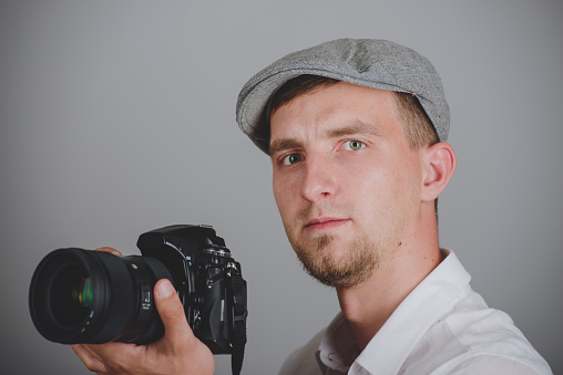 Young man using a professional camera in studio