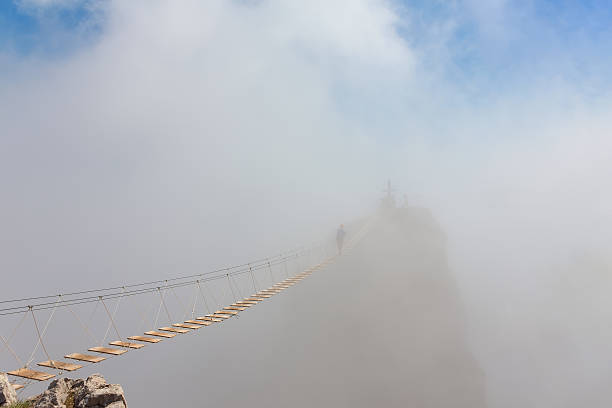 istock Man in fog over chasm 615922458