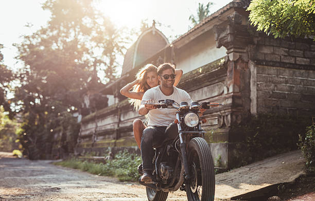 istock Man riding on a fast motorcycle with girlfriend 615923476