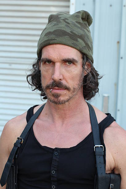 istock Scruffy man with a camouflage beanie 615926606