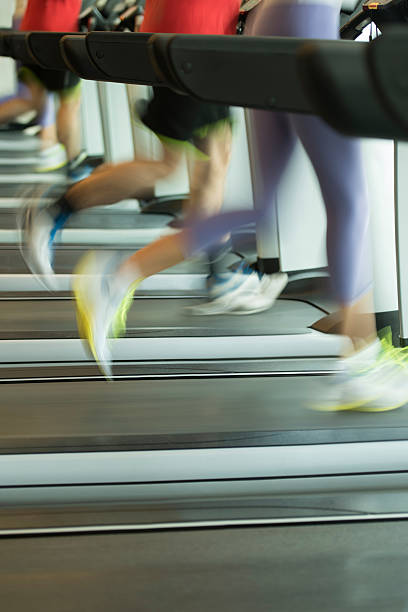 istock Man and woman running on treadmill 615926640