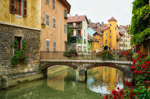 Historic buildings that line the river flowing through the old town of Annecy in France.