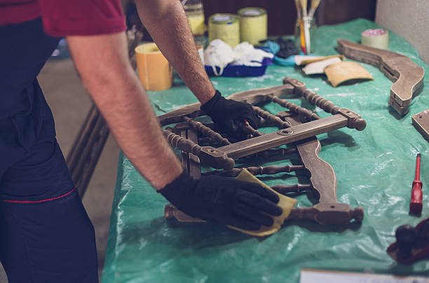 istock Carpenter sanding baby cradle close up 615927804