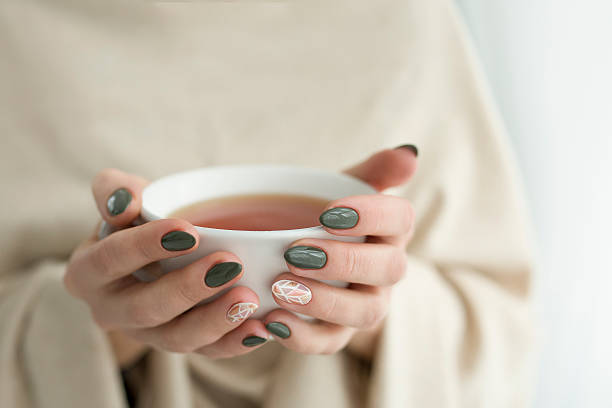 istock well-groomed hands with a cup of tea 615974078