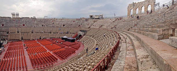 Panorama of roman amphitheatre in Verona, Italy Verona, Italy - September 16, 2016: The Verona Arena is a roman amphitheatre built in 30 AD. It is being prepared for a large concert, while tourists wander around. verona opera stock pictures, royalty-free photos & images