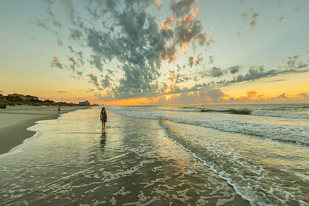 istock Blonde Woman Walking On The Beach 615977298