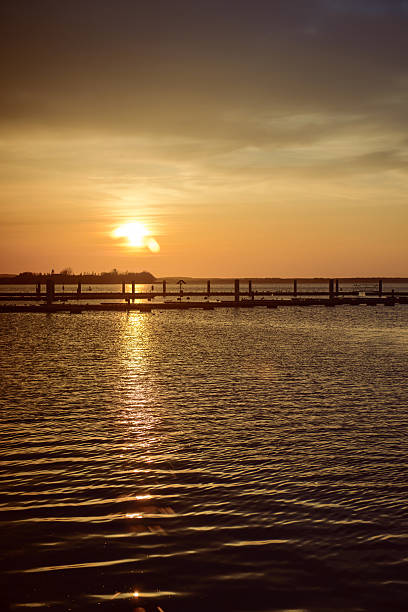 istock Yacht port over orange sunset 615982228