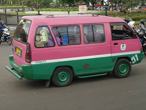 Bundung, Indonesia - September 28, 2016: Passenger van is on the road in Bundung. People are inside the van.