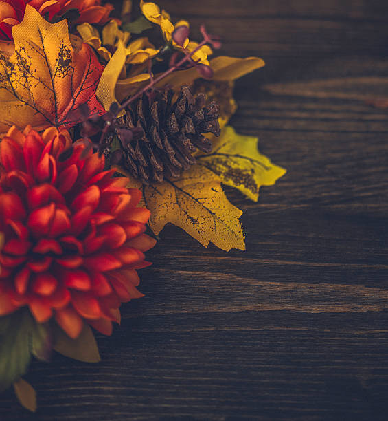 istock Thanksgiving floral fall arrangement with pinecone, leaves and rustic wood 615985146