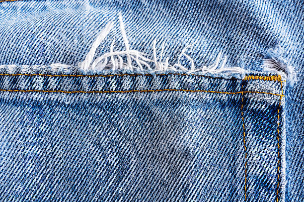 istock Close up back of old denim jean texture. 615985180