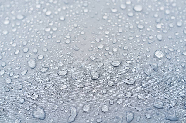 istock Water droplets on grey fiber waterproof fabric. 615985514