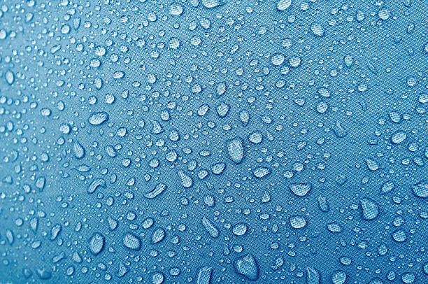istock Water droplets on blue fiber waterproof fabric. 615985628