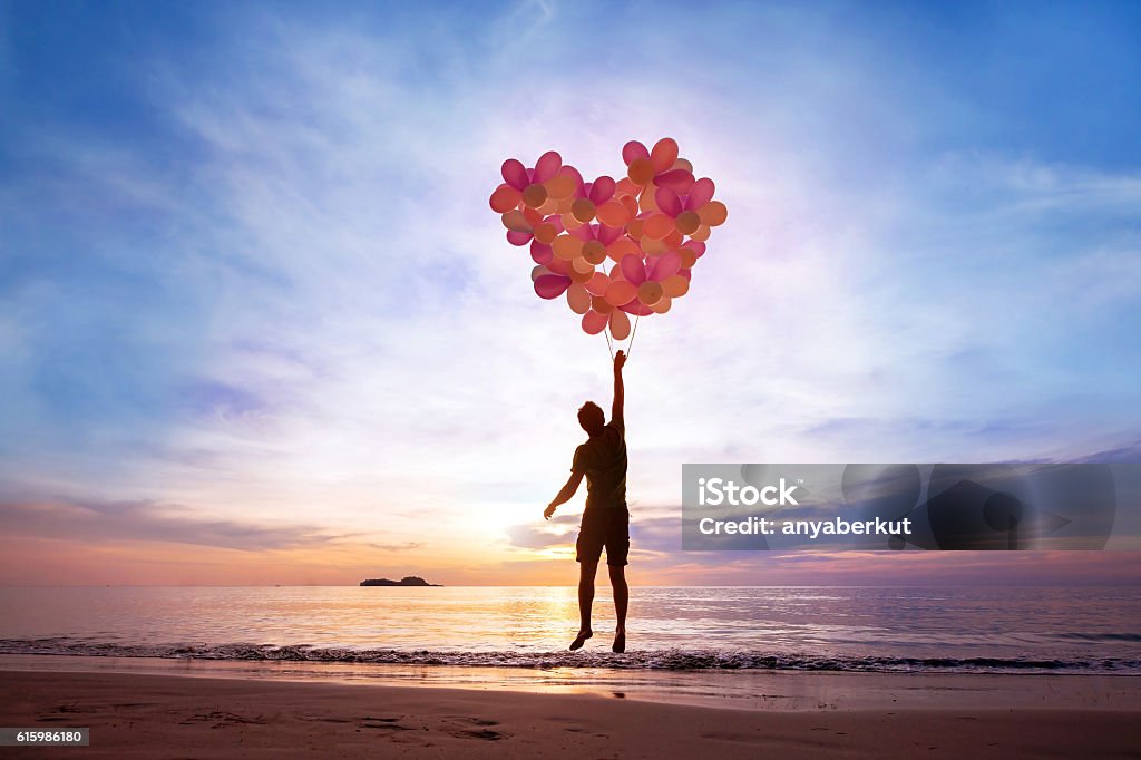 love concept love concept, man flying with heart from balloons, fall in love Love - Emotion Stock Photo