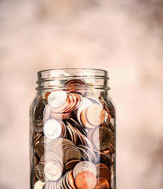 istock Glass jar filled with American currency 615986828