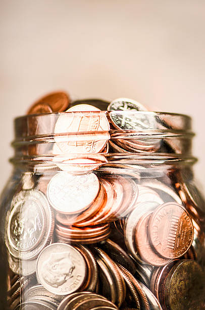 istock Glass jar filled with American currency 615986846