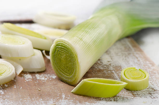 istock Fresh leeks on a wooden cutting board. 615990400