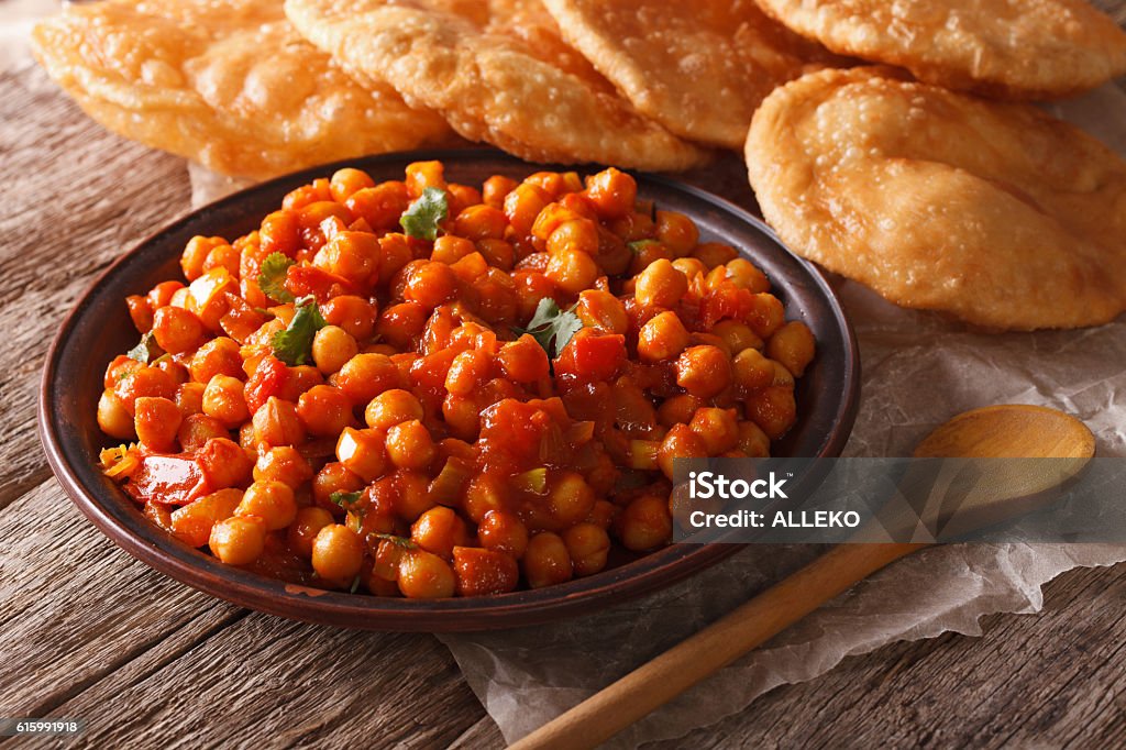 Indian Chana masala and puri bread close-up. horizontal Indian Chana masala and puri bread close-up on the table. horizontal Bean Stock Photo