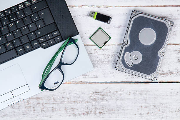 istock laptop, glasses, harddisk, CPU and flash drive on the table 615992130