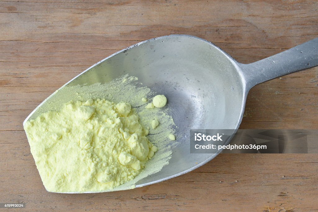 sulfur powder on iron scoop Sulphur Stock Photo