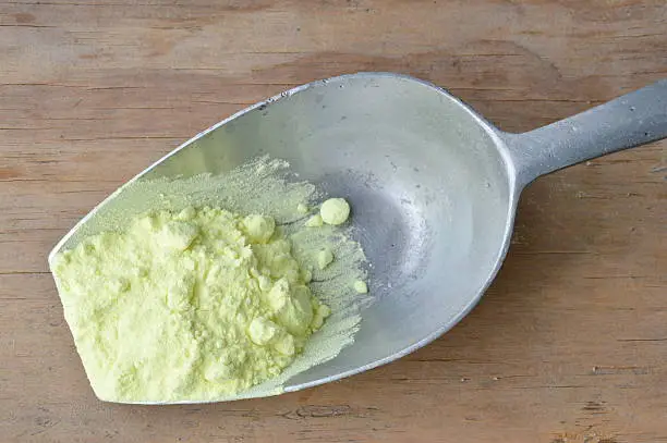 sulfur powder on iron scoop