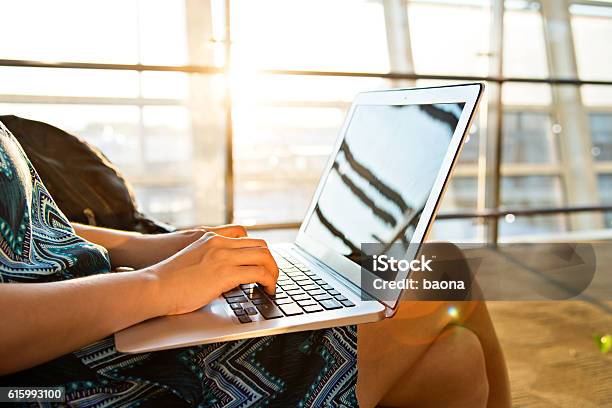 Young Woman Using Laptop Computer At Airport Stock Photo - Download Image Now - Airport, Laptop, Adult