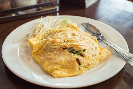 Fried noodle Thai style with egg omelet, Fried Noodles in Egg Wrap.