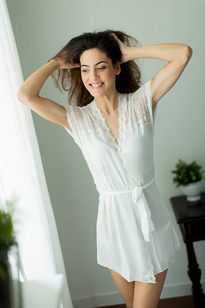 istock Pretty young woman by the window 615998946